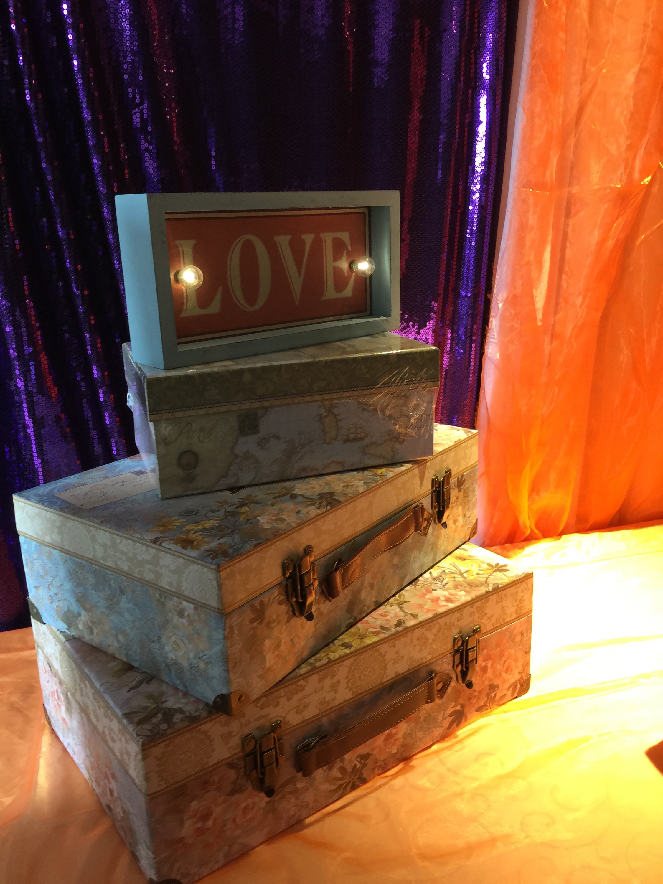 Suitcases stacked together to welcome the guests to the La Tundra Hall for the wedding reception.